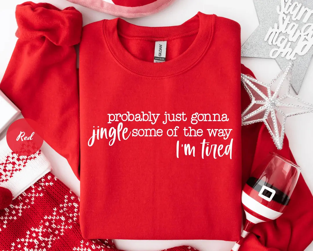 Red GD crewneck sweatshirt with script lettering that reads probably just gonna jingle some of the way I'm tired, flat lay view.
