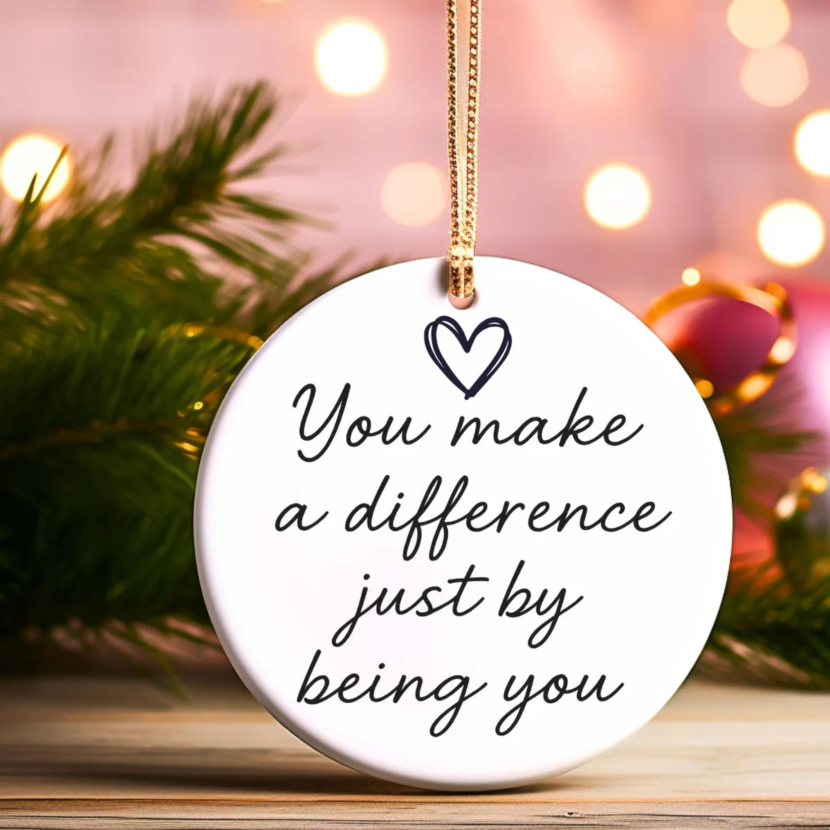 Alternate view of a round ceramic ornament with the visible You Make Every Day a Little Brighter message.