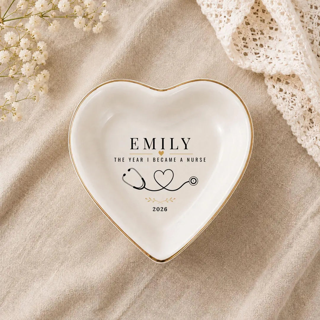 Heart-shaped ceramic nurse ring dish with gold rim, a name, stethoscope heart design and a year