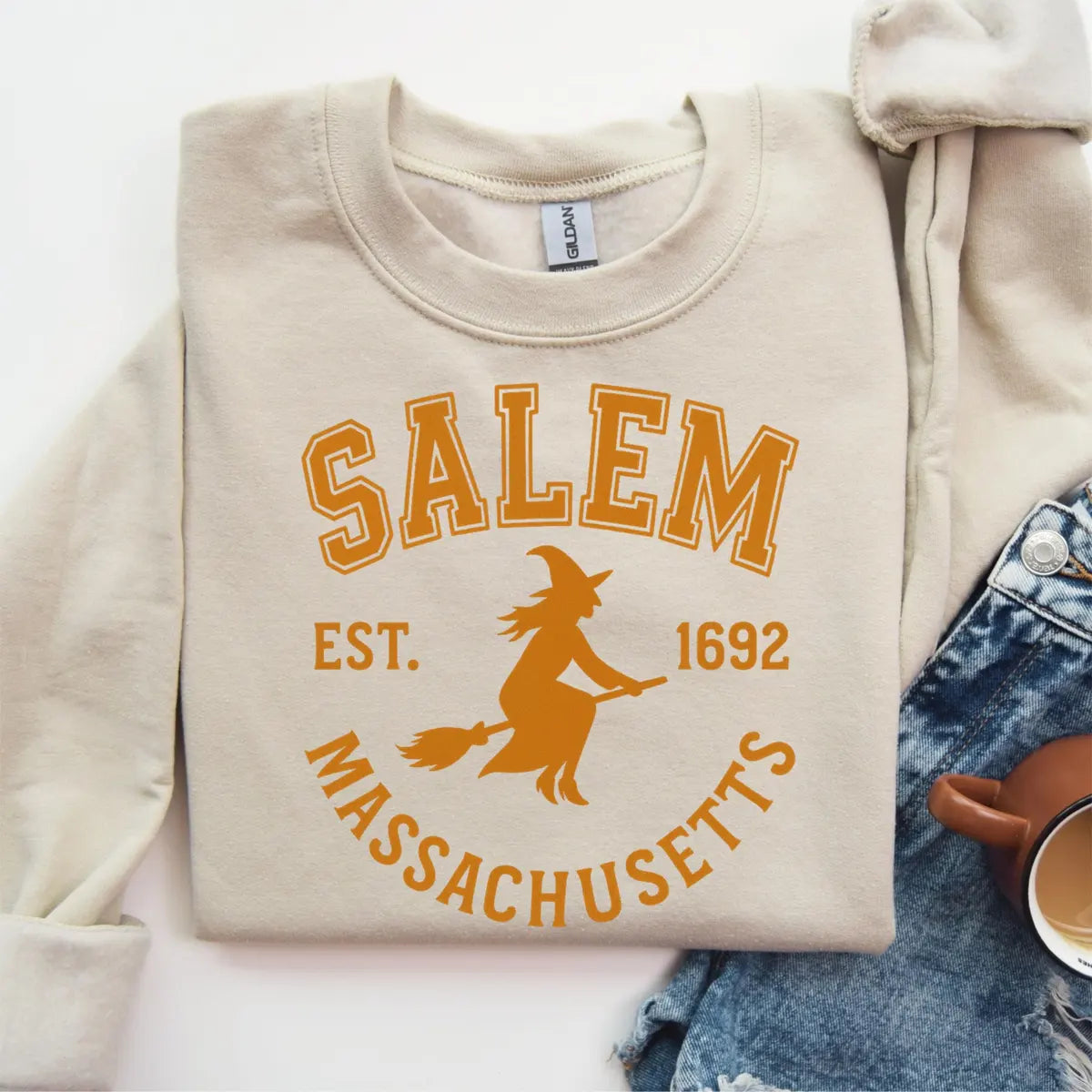 Sand Crewneck sweatshirt with printed Salem Witch design, hero view.