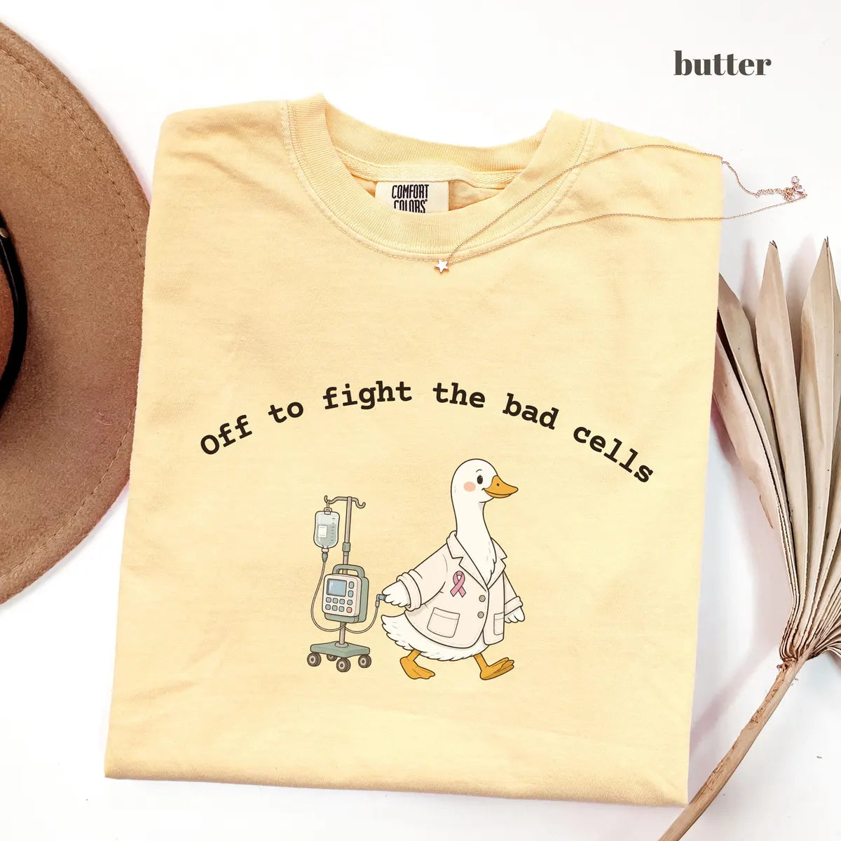 Butter Comfort Colors 1717 T-shirt with Off to Fight the Bad Cells design worn by a model