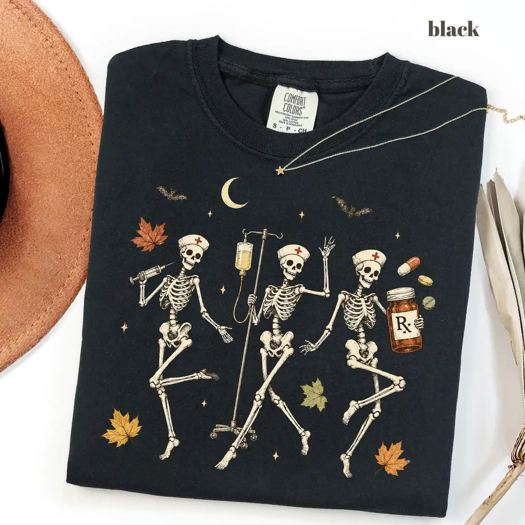 Black CF Comfort Colors 1717 T-shirt with Halloween Nurse Skeleton design worn by a model