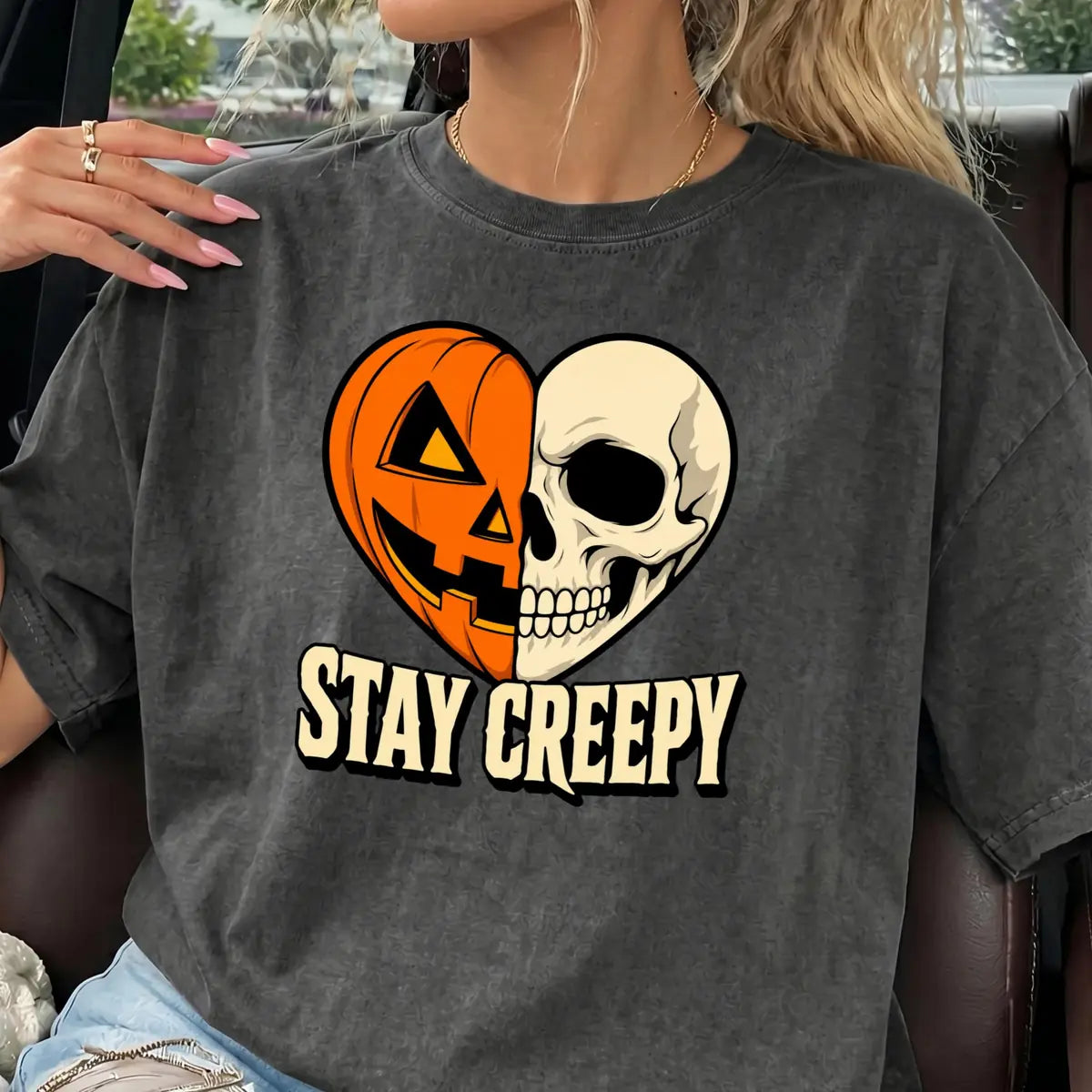 Comfort Colors T-shirt in Pepper worn by model featuring Stay Creepy pumpkin skeleton heart graphic