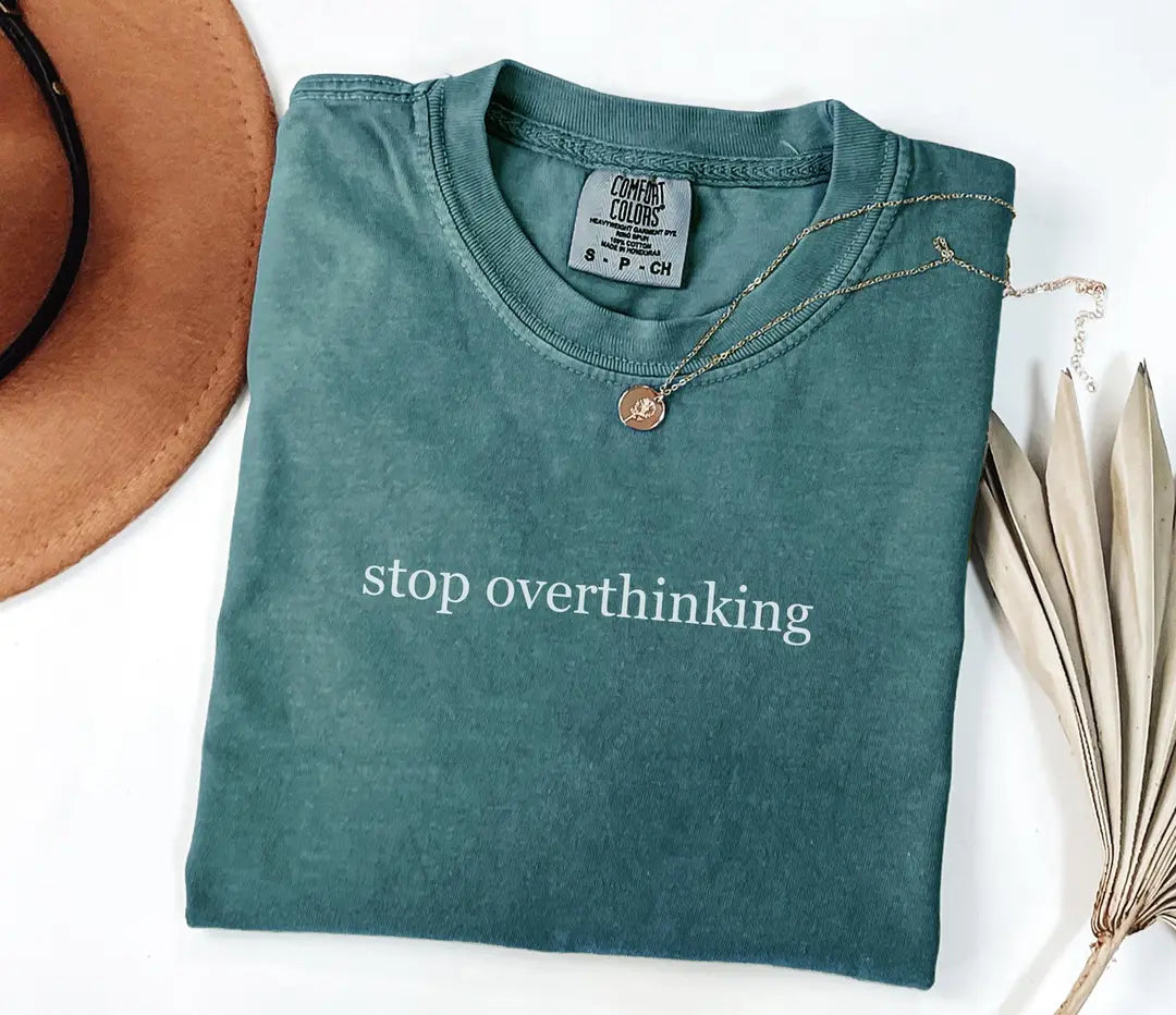 Blue Spruce Comfort Colors T-shirt with white 'stop overthinking' lettering, folded mockup.