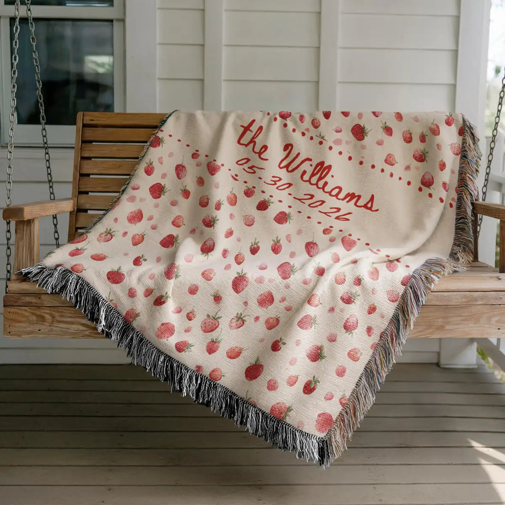 Close-up of the personalized strawberry woven blanket with texture and fringe detail