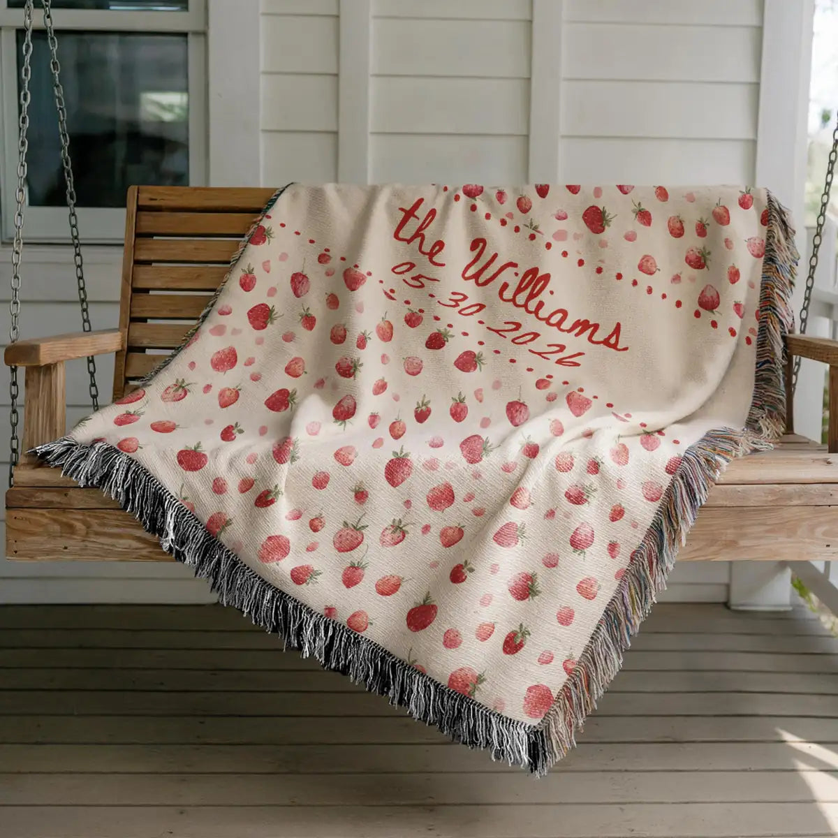 Close-up of the personalized strawberry woven blanket with texture and fringe detail