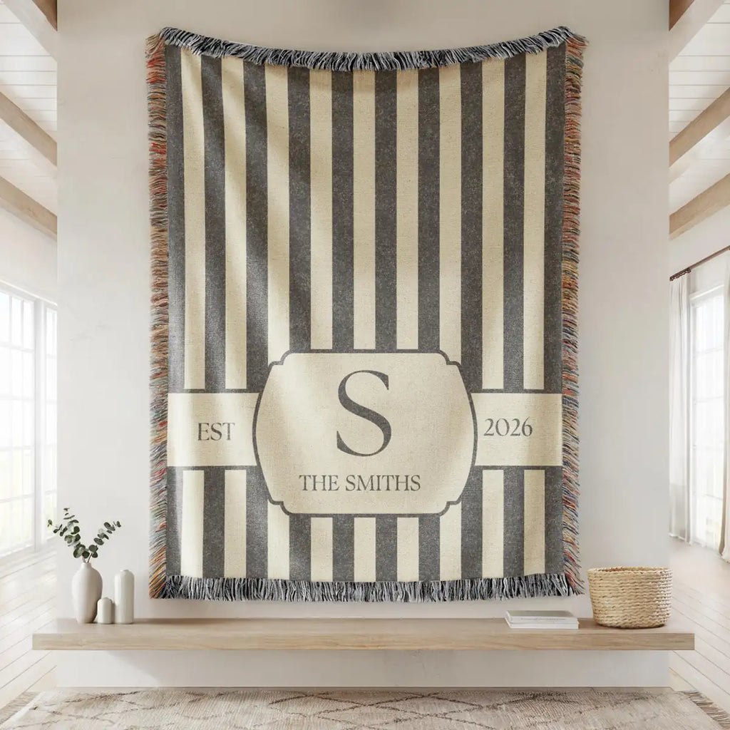 Close-up of the personalized striped crest woven blanket with texture and fringe detail