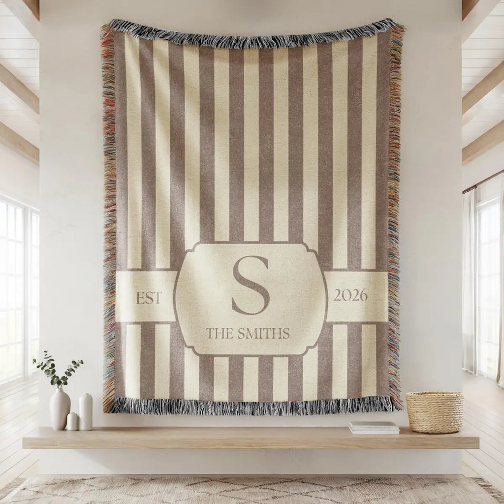 Close-up of the personalized striped crest woven blanket with texture and fringe detail