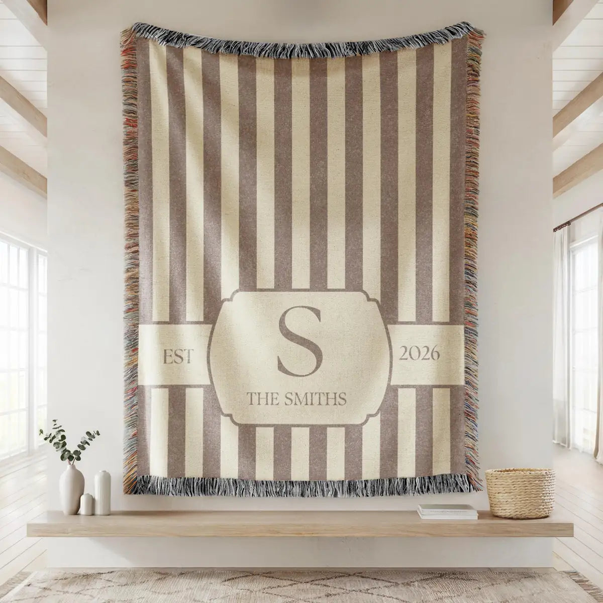 Close-up of the personalized striped crest woven blanket with texture and fringe detail