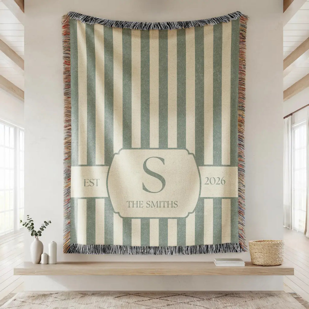Close-up of the personalized striped crest woven blanket with texture and fringe detail