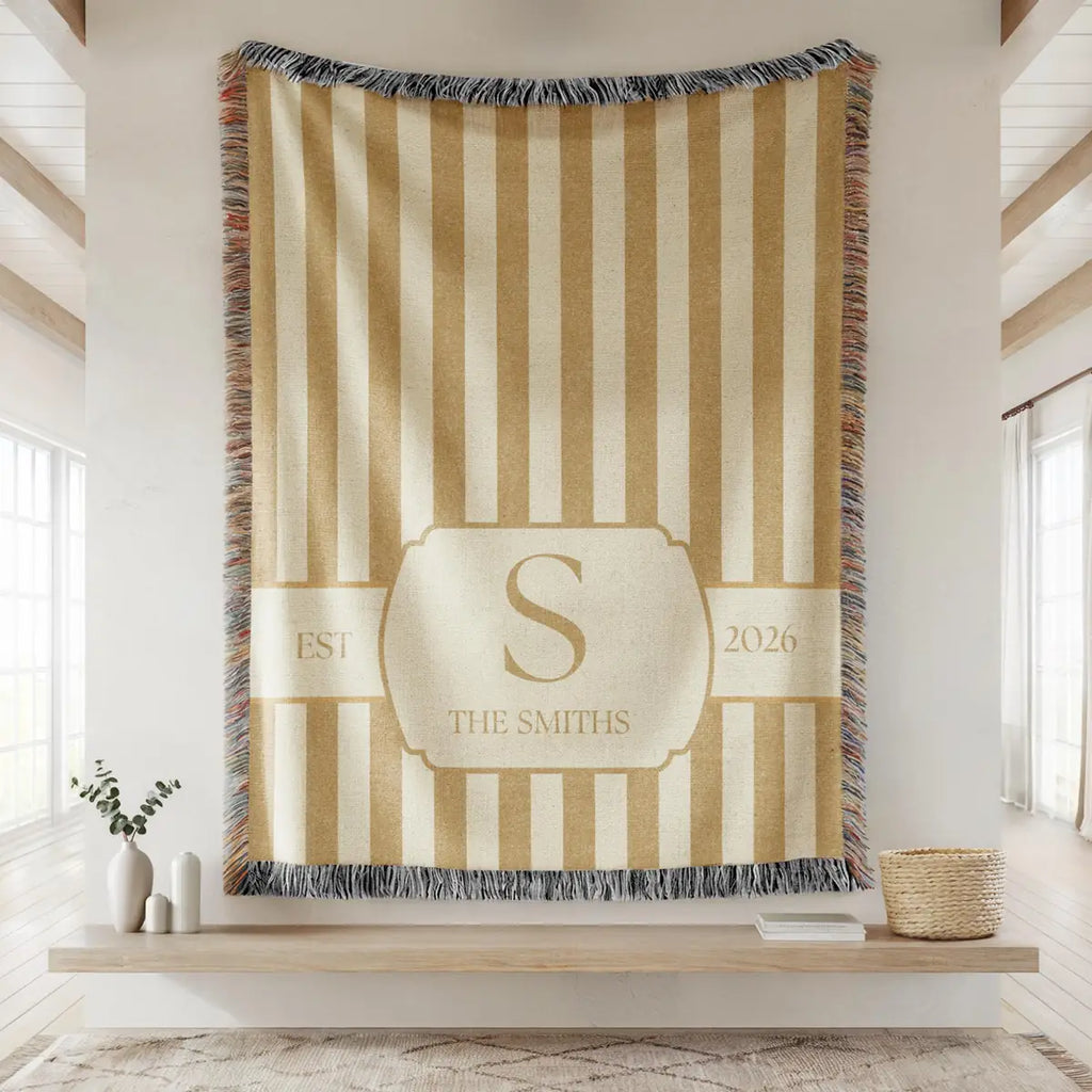 Close-up of the personalized striped crest woven blanket with texture and fringe detail