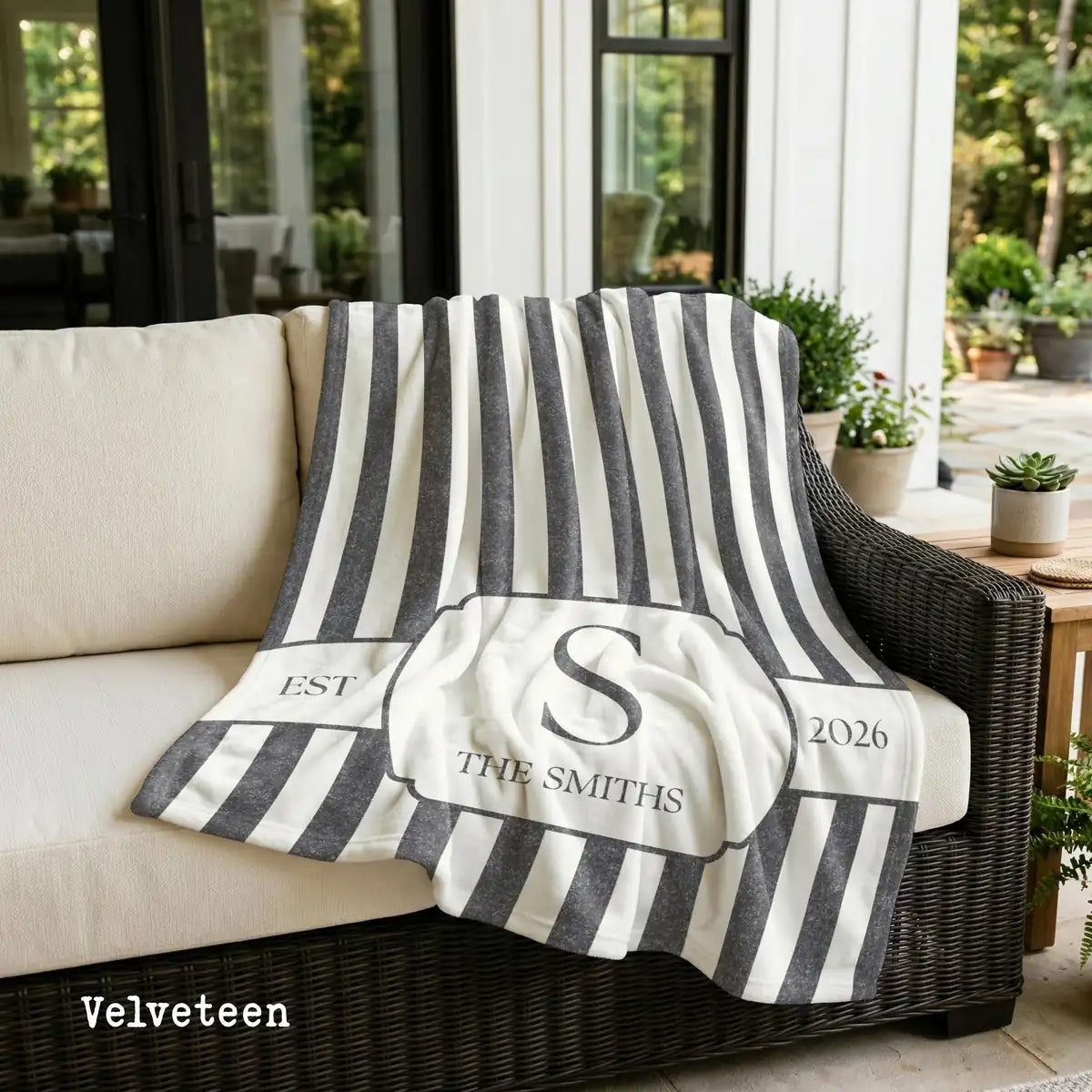 Close-up of the personalized striped crest woven blanket with texture and fringe detail
