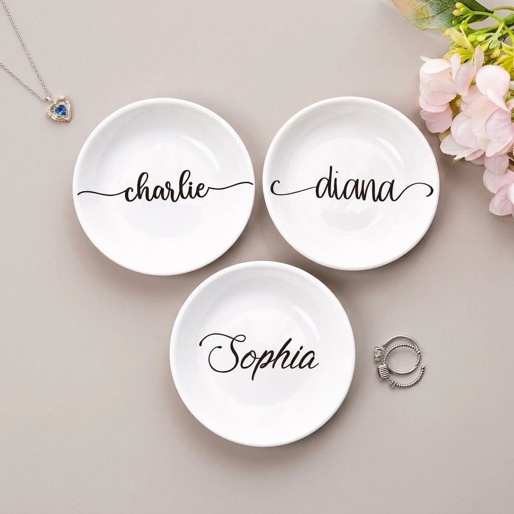 Two personalized name ring dishes side by side on blush background