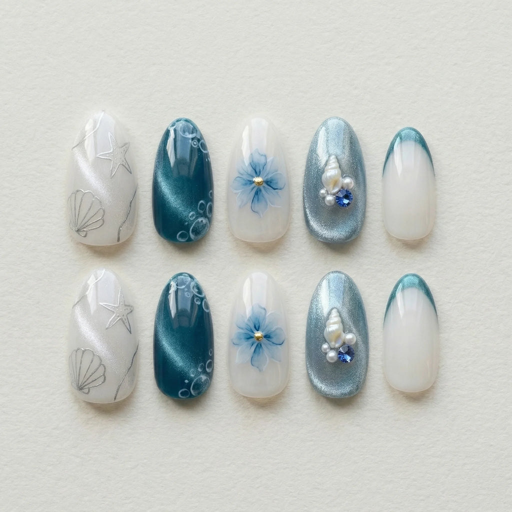 teal cat eye 3d almond medium press on nails ocean seashell charm flat lay 01