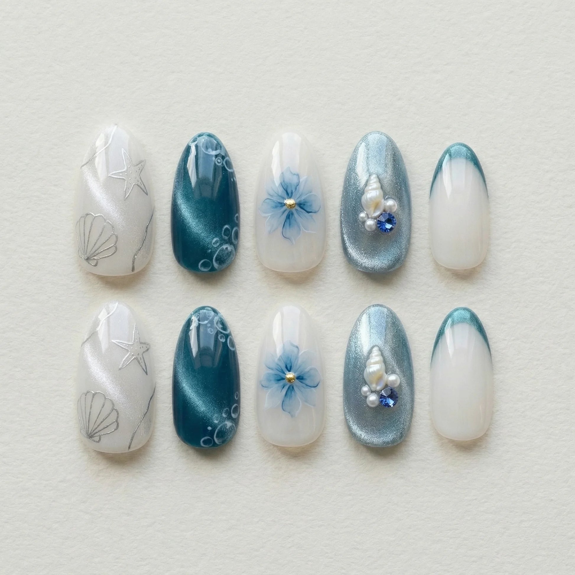 teal cat eye 3d almond medium press on nails ocean seashell charm flat lay 01