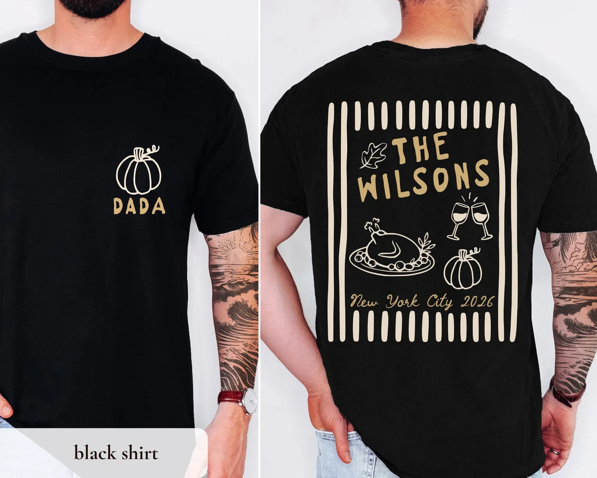 Man in a Black Comfort Colors tee, front with a tan pumpkin and DADA, back with The Wilsons over a turkey and wine glasses