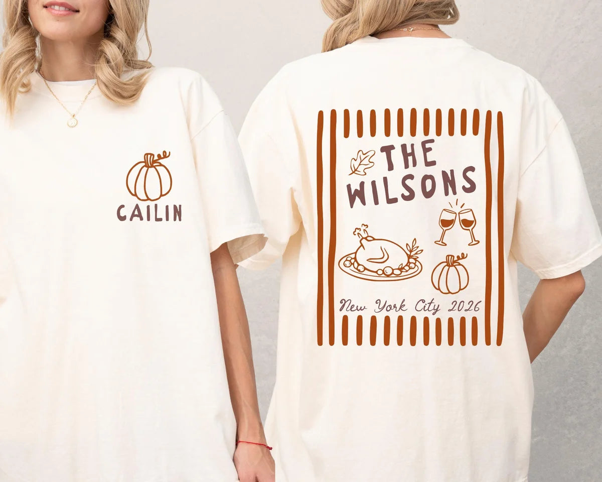 Two women in Ivory tees, front with a pumpkin and Cailin, back with The Wilsons over a roast turkey and wine glasses