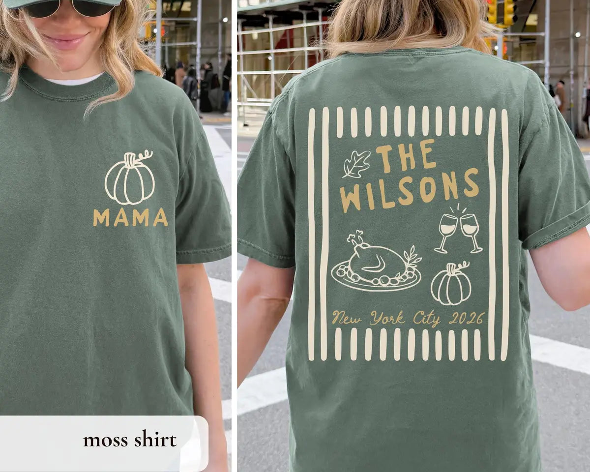 Woman in a Moss green Comfort Colors tee, front with a pumpkin and MAMA, back with The Wilsons, a turkey and wine glasses