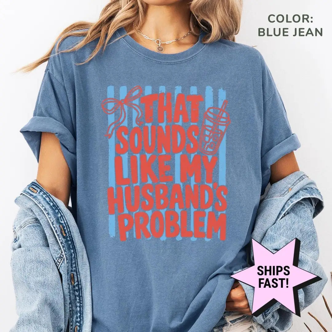 Woman in a Blue Jean Comfort Colors tee and a denim jacket with red husband's problem lettering on light blue stripes