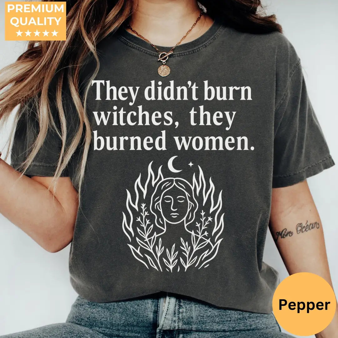 They Didn't Burn Witches They Burned Women graphic Comfort Colors T-shirt in Pepper, main product photograph.