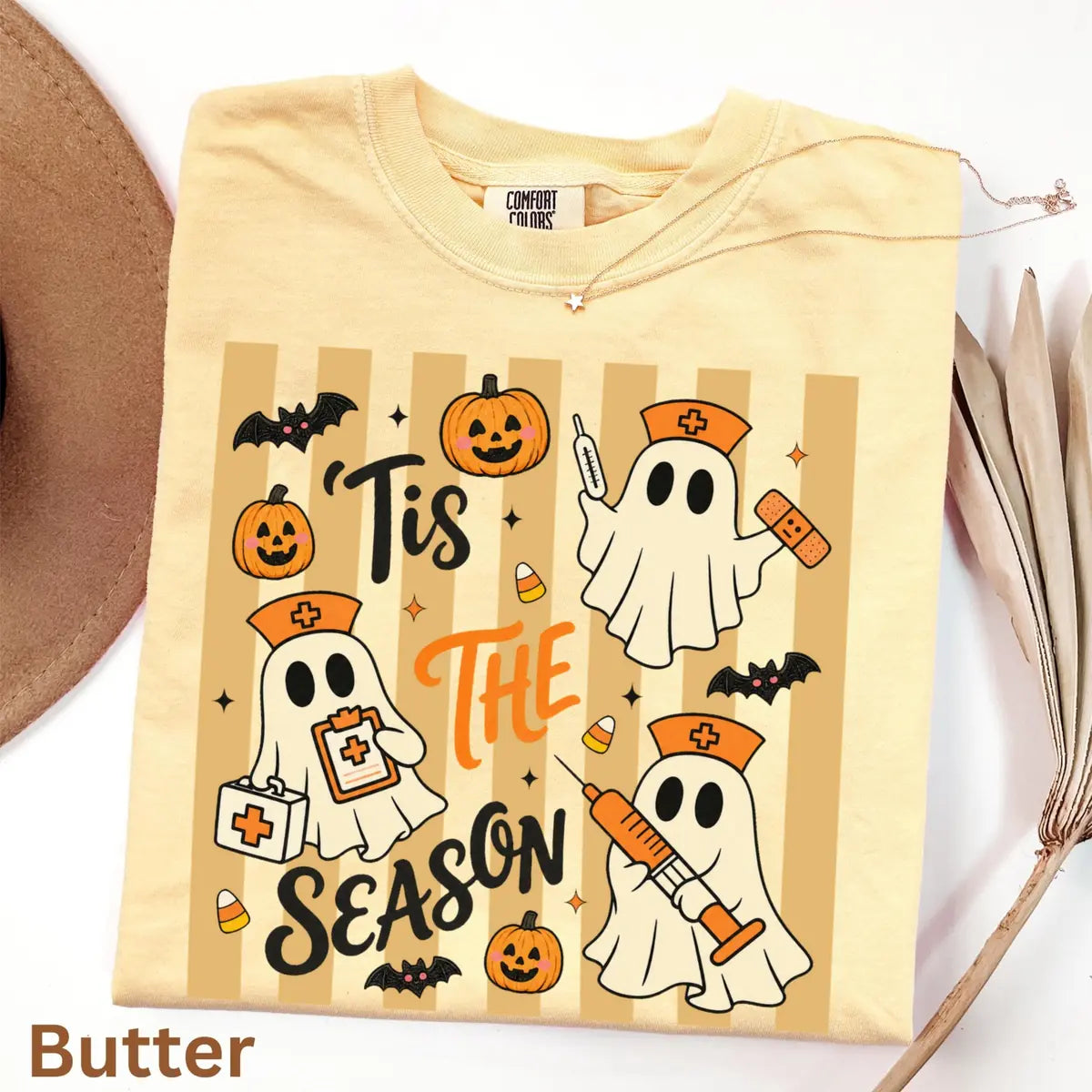 Comfort Colors T-shirt flatlay in Butter color featuring Tis The Season nurse ghosts graphic