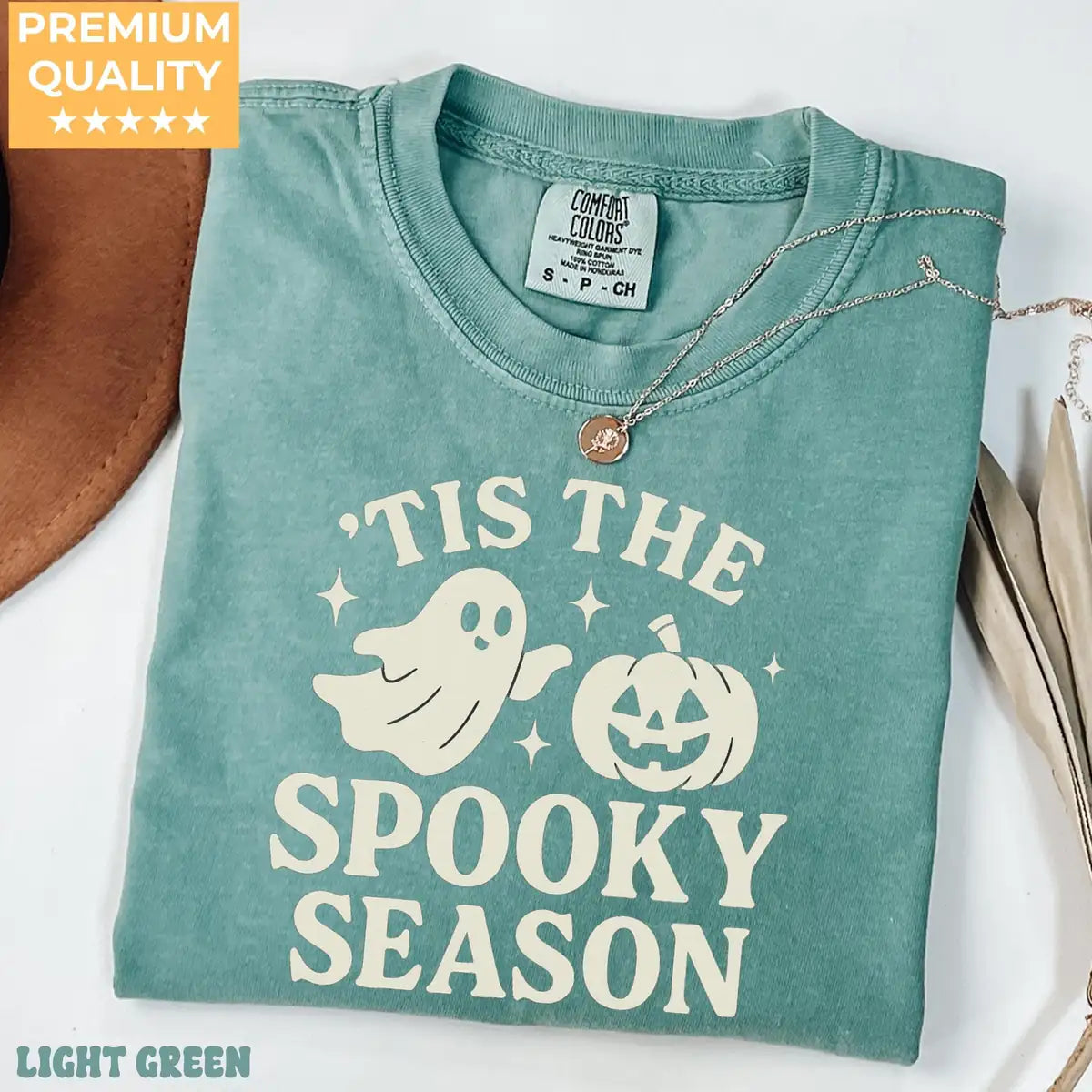 Comfort Colors T-shirt in Light Green color featuring Tis The Spooky Season ghost and pumpkin graphic
