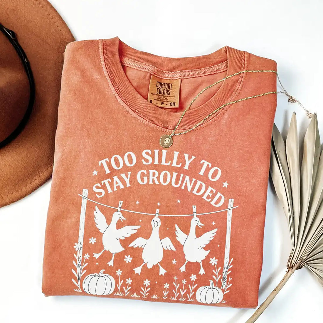 Comfort Colors T-shirt in Moss color featuring Too Silly To Stay Grounded geese graphic