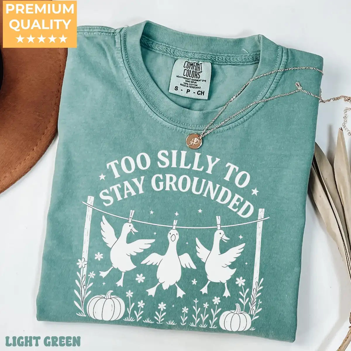 Comfort Colors T-shirt in Yam color featuring Too Silly To Stay Grounded geese graphic