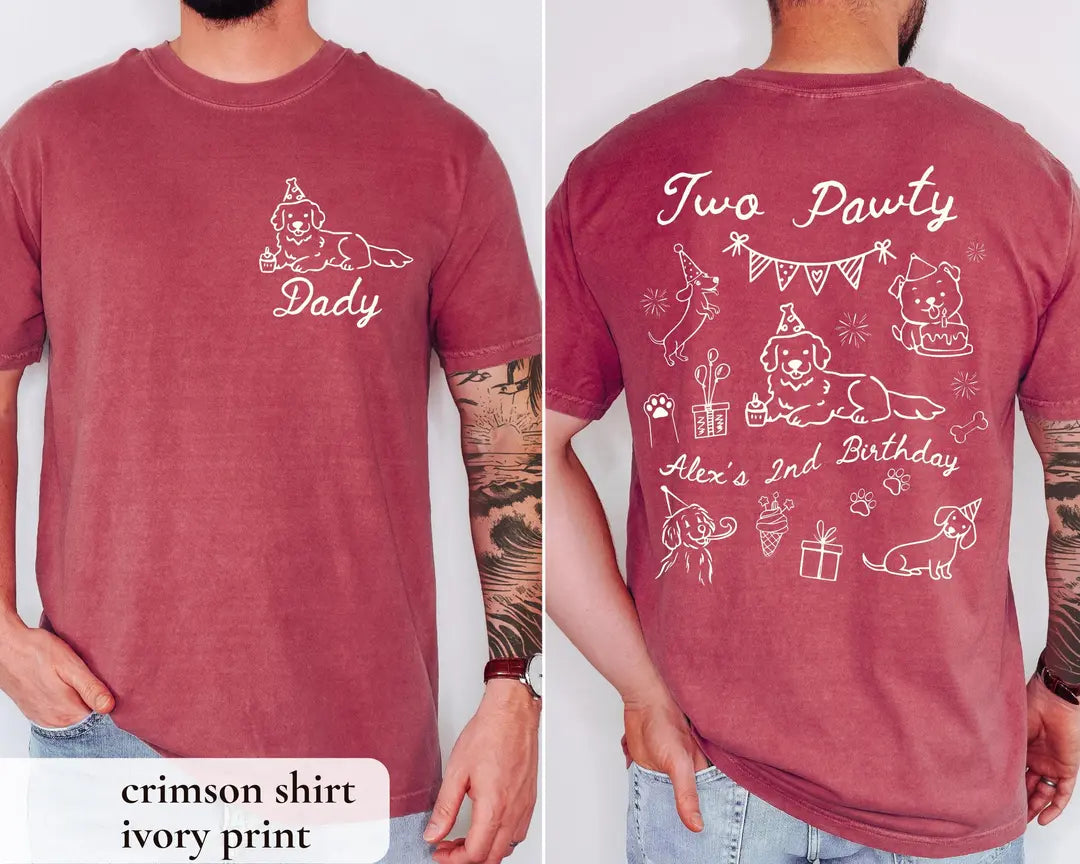 Man in a Crimson Comfort Colors tee, front with an ivory dog and Dad script, back with Two Pawty and puppy doodles