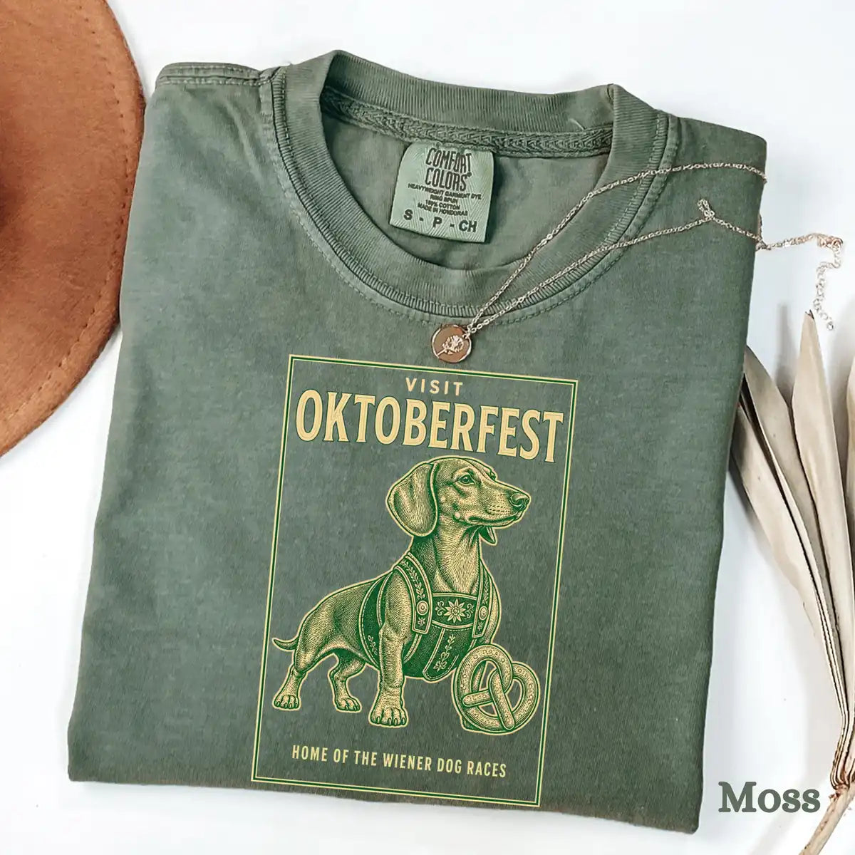 Blue Comfort Colors T-shirt mockup showing Visit Oktoberfest Dachshund Halloween design