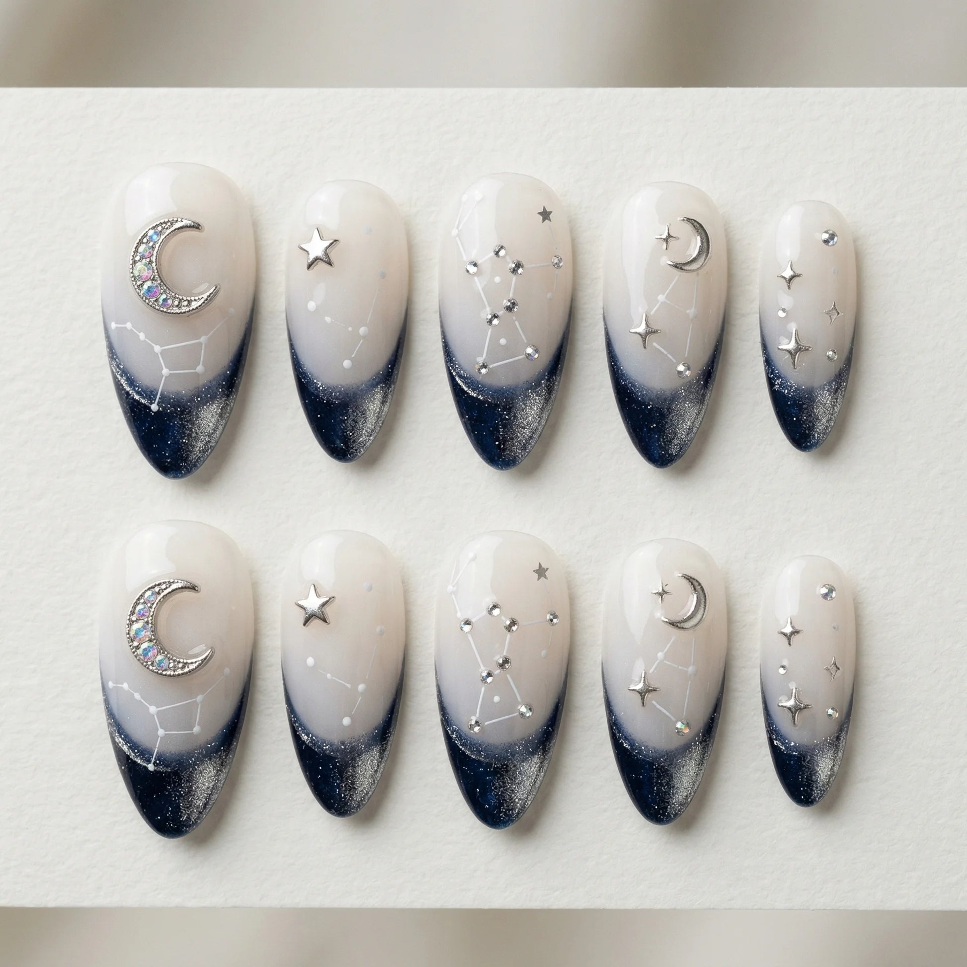 white navy hand painted stiletto medium press on nails moon star constellation flat lay 01