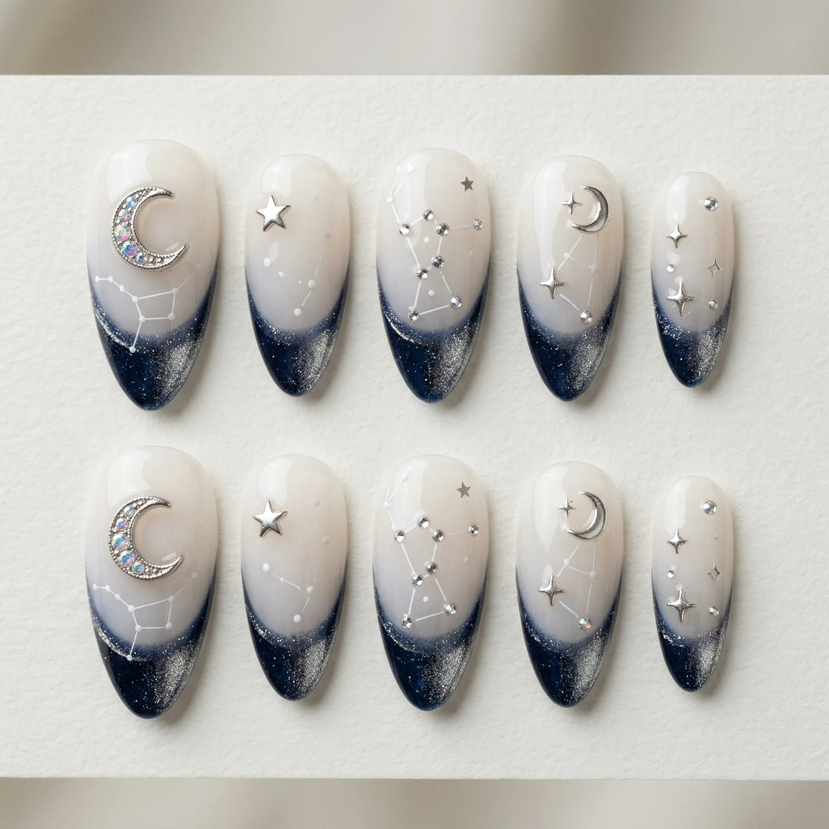 white navy hand painted stiletto medium press on nails moon star constellation flat lay 01