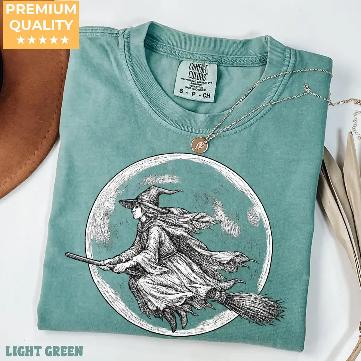 Comfort Colors T-shirt in Light Green featuring flying witch graphic